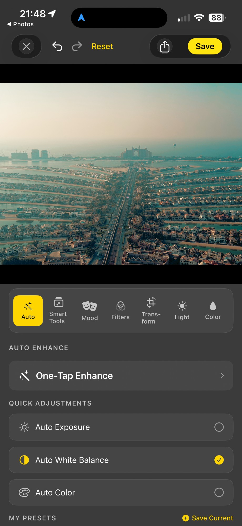 Acetate editor's Auto tab over an aerial photo of Palm Jumeirah at golden hour, showing the One-Tap Enhance card and Quick Adjustments toggles for Auto Exposure, Auto White Balance, and Auto Color