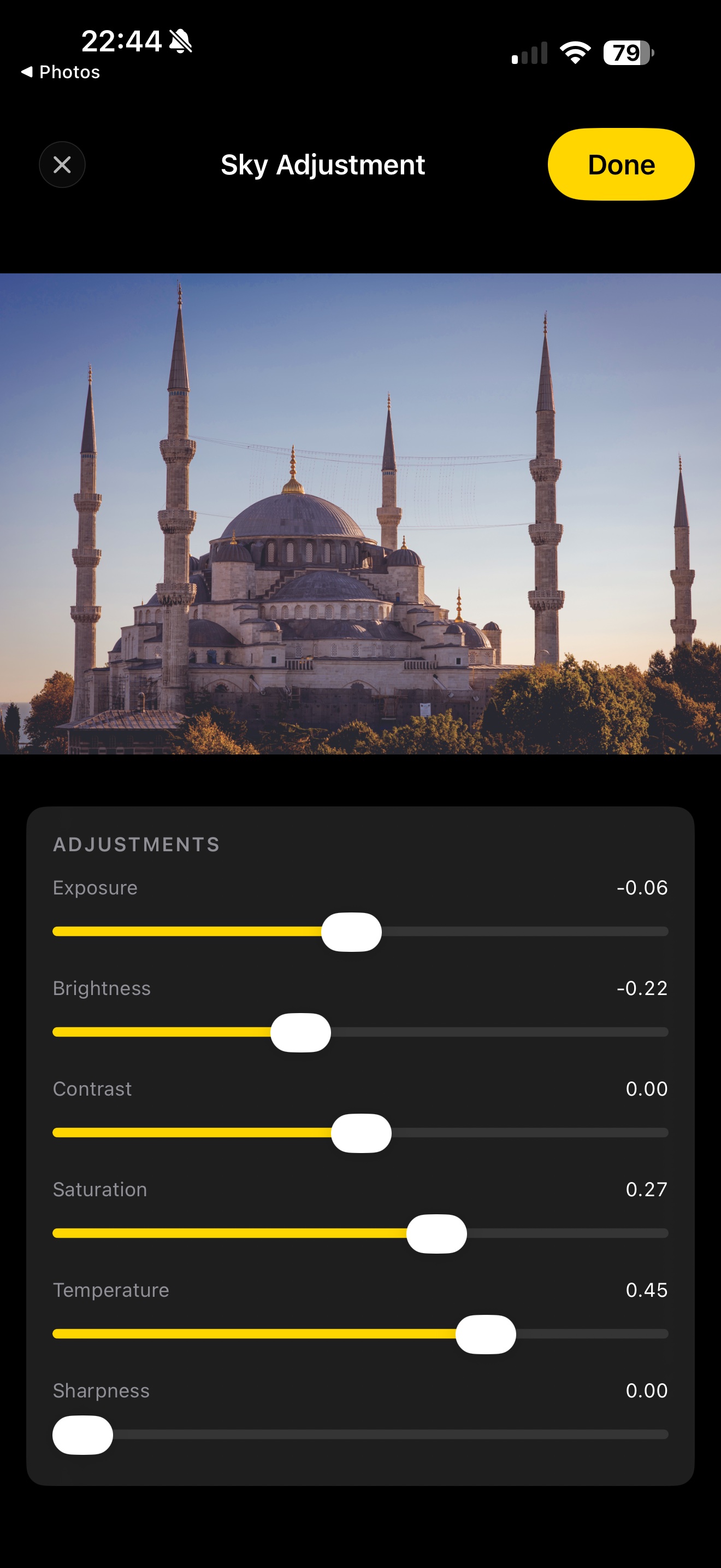 Acetate editor with a Sky selective adjustment applied to a photo of the Blue Mosque at dusk — Vision has detected the sky and a slider panel shows Exposure, Brightness, Contrast, Saturation, Temperature, and Sharpness all live-editable