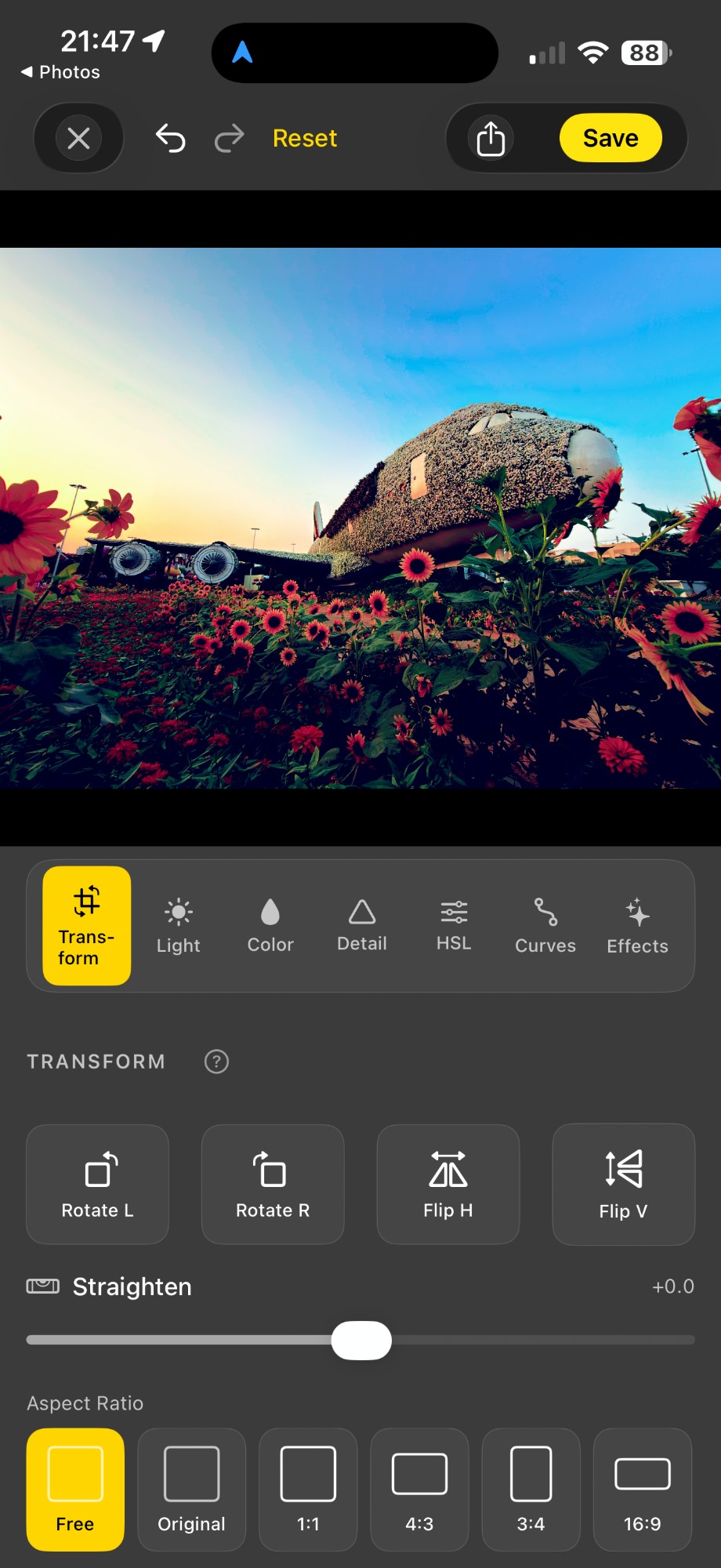 Acetate editor's Transform tab over a Dubai Miracle Garden photo of an airplane covered in flowers and surrounded by sunflowers, with tactile Rotate L / Rotate R / Flip H / Flip V buttons, a Straighten slider, and Aspect Ratio chips